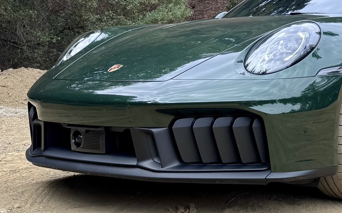 Close detail of the nose, hood crest, and headlight in oak green paint